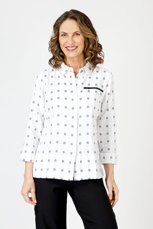 Cali Girls Betty Check Embroidered Blouse in White/Black.  Gingham check with contrast color embroidery.  Pointed collar button down blouse with hidden button placket.  3/4 sleeve with fold back cuff and button detail.  Coral zipper detail above left breast.  Back yoke with ring tab and inverted back pleat.  Relaxed fit._59841889599854