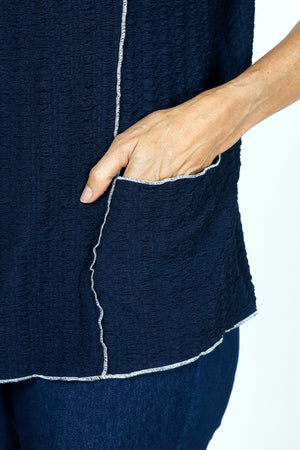 Top Ligne Texture Knit Stitch Pocket Top in Navy.  Crew neck 3/4 sleeve top in lightweight puckered fabric.  Off center front seaming with white top stitching and hidden front pocket.  Plain back.  White stitch trim at neck, hem and cuff. Relaxed fit._59584341279086