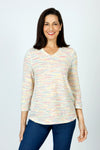 Top Ligne Grid V Neck Shirttail Top in Multi.  V neck 3/4 sleeve top with shirttail hem.  Raised miniature blocks in multi-colors in a grid pattern on white.  A line shape.  Relaxed fit._t_59598244348270