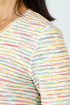 Top Ligne Grid V Neck Shirttail Top in Multi.  V neck 3/4 sleeve top with shirttail hem.  Raised miniature blocks in multi-colors in a grid pattern on white.  A line shape.  Relaxed fit._t_59598244315502