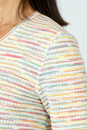 Top Ligne Grid V Neck Shirttail Top in Multi.  V neck 3/4 sleeve top with shirttail hem.  Raised miniature blocks in multi-colors in a grid pattern on white.  A line shape.  Relaxed fit._59598244315502