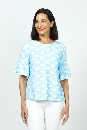 Top Ligne Neon Flowers Flounce Tee in Blue. Blue textured velour flours on a white background.  Crew neck tee with elbow length sleeve with ruffled cuff.  A line shape.  Relaxed fit._35730168185032