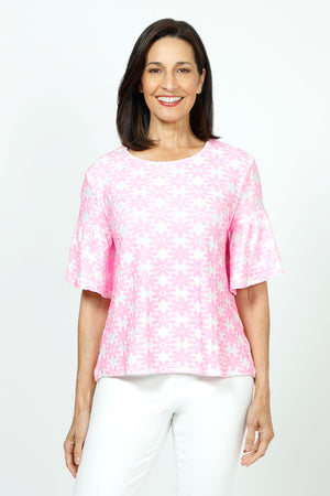 Top Ligne Neon Flowers Flounce Tee in Pink. Neon pink textured velour flours on a white background. Crew neck tee with elbow length sleeve with ruffled cuff. A line shape. Relaxed fit._35730168217800