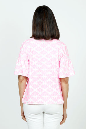 Top Ligne Neon Flowers Flounce Tee in Pink. Neon pink textured velour flours on a white background. Crew neck tee with elbow length sleeve with ruffled cuff. A line shape. Relaxed fit._35730168283336