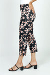 Holland Ave Susan Daisy Fun Crop Pant.  Pink and red daisies on a black background.  No waistband pull on pant with faux zipper placket.  Snug through stomach and thigh, falls straight to hem.  Side leg slits.  Inseam: 24"_t_52987900756334