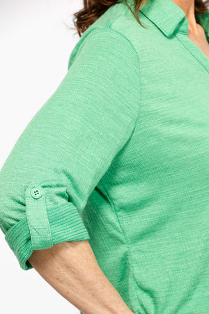 Top Ligne Roll Tab Button Down Top in Kelly Green. Pointed collar open v neck button down with 3/4 roll button tab sleeves. Curved hem. Lightly textured fabric. Relaxed fit._35439032697032
