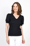 Top Ligne Pucker Ruffle Sleeve Top in Black. V neck puckered top with short gathered sleeve and smocked cuff with ruffle trim. Relaxed fit._t_35571204718792