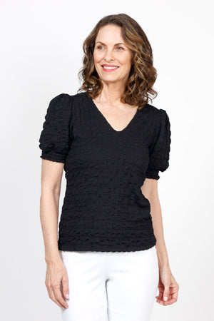 Top Ligne Pucker Ruffle Sleeve Top in Black. V neck puckered top with short gathered sleeve and smocked cuff with ruffle trim. Relaxed fit._35571204718792