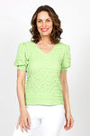 Top Ligne Pucker Ruffle Sleeve Top in Kiwi. V neck puckered top with short gathered sleeve and smocked cuff with ruffle trim. Relaxed fit._t_35571204653256