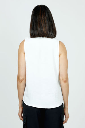 Top Ligne Sleevless Ruffle Tank in White. V neck sleeveless top with ruffle trim at the neck and down the front. Curved hem. Relaxed fit.Top Ligne Sleeveless Ruffle Tank in White. V neck sleeveless top with ruffle trim at the neck and half down the front. Curved hem. Relaxed fit._35748038705352