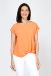 Top Ligne Airflow Twist Hem Top in Cantaloupe.  Lightly textured crew neck cap sleeve top with twist hem on left side. Keyhole opening at back neck with button closure.  Relaxed fit._t_59759859532142