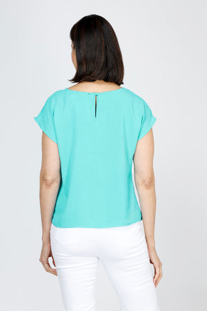 Top Ligne Airflow Twist Hem Top in Turquoise.  Lightly textured crew neck cap sleeve top with twist hem on left side. Keyhole opening at back neck with button closure.  Relaxed fit._59759859269998