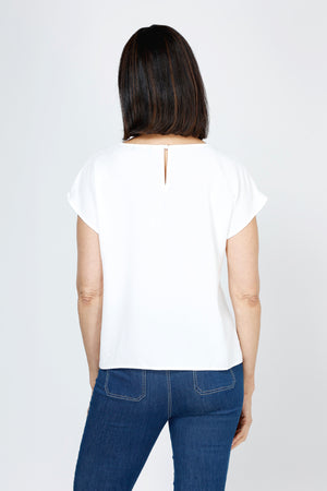 Top Ligne Airflow Twist Hem Top in White.  Lightly textured crew neck cap sleeve top with twist hem on left side. Keyhole opening at back neck with button closure.  Relaxed fit._59759859368302