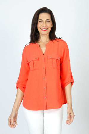 Top Ligne 2 Pocket Button Roll Tab Top in Coral.  Crew neck banded collar with notched v neck.  Button down.  2 breast patch pockets with button flap.  3/4 sleeve with button roll tab.  Gold buttons. Shoulder epaulets.  Shirttail hem.  Relaxed fit._59598820049262