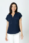 Top Ligne Cap Sleeve Pocket Top in navy.  Pointed collar pullover with split v placket.  2 breast flap patch pockets.  White top stitching at shoulders pockets and edges. Back yoke. Curved hem.  Relaxed fit._t_59678090756462