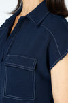 Top Ligne Cap Sleeve Pocket Top in navy.  Pointed collar pullover with split v placket.  2 breast flap patch pockets.  White top stitching at shoulders pockets and edges. Back yoke. Curved hem.  Relaxed fit._t_59678090821998