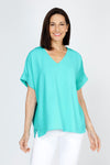 Top Ligne Airflow Dolman V Neck Top in Turquoise.  Lightly textured and airy top.  V neck with short cuffed dolman sleeves.  A line shape.  Relaxed fit._t_59764799635822