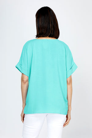 Top Ligne Airflow Dolman V Neck Top in Turquoise.  Lightly textured and airy top.  V neck with short cuffed dolman sleeves.  A line shape.  Relaxed fit._59764799832430