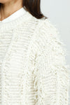 Lolo Luxe Fringe Cardigan in Ivory.  Crew neck open front cardigan with hook and eye closure at neck line.  Open weave with vertical ribbing.  Fringe detail throughout.  Long sleeves.  Rib trim at neck, hem and cuff.  Relaxed fit._t_52987884044654