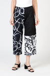 Top Ligne Mixed Scribbles Crinkle Crop in Black/White. Pull on pant with elastic waist.  Right leg in black with white print.  Left leg, 1/2 solid black at top, bottom reversed print white background with black scribble.  Wide leg.  25 1/2" inseam._t_59835023491438