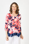 Top Ligne Blurred Flower Tee in Coral.  Coral and white blurred flowers on a navy background.  Scoop neck 3/4 sleeve tee with sewn edges.  Center raised seam.  Inseam solid navy asymmetrical flounce at hem.  Relaxed fit._t_59845645926766