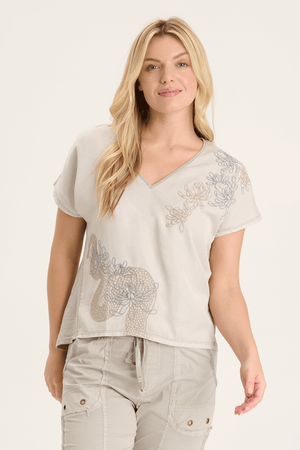 XCVI Jolina Embroidery Top in Beige.  Mixed media v neck top.  Front is soft satiny twill with drawn floral embroidery. Back is slub jersey.  Dolman short sleeve.  Jersey trim at neckline.  Relaxed fit._59594311434606