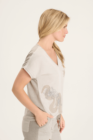 XCVI Jolina Embroidery Top in Beige.  Mixed media v neck top.  Front is soft satiny twill with drawn floral embroidery. Back is slub jersey.  Dolman short sleeve.  Jersey trim at neckline.  Relaxed fit._59594311401838