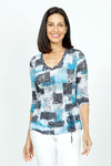 Top Ligne Brushed Patches Grommet Crinkle Top.  Light blue, black and white brushed screen printed patches over a jacquard rose print background.  V neck 3/4 sleeve top.  Grommet and lace tie in black at left front.  Black trim at neckline.  Crinkle fabric.  Relaxed fit._t_35741023535304