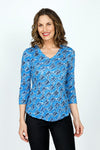 Top Ligne Rose Print V neck in Blue.  Blue on blue jacquard rose print overprinted in  a black diagonal geometric pattern.  V Neck, 3/4 sleeve crinkle top with curved hem. Relaxed fit._t_59570767790446