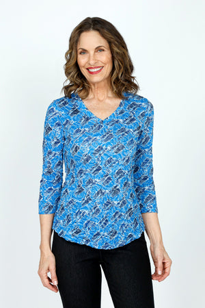 Top Ligne Rose Print V neck in Blue.  Blue on blue jacquard rose print overprinted in  a black diagonal geometric pattern.  V Neck, 3/4 sleeve crinkle top with curved hem. Relaxed fit._59570767790446