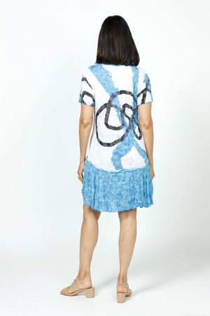 Top Ligne Doodle Lines Dress in Blue. Large abstract scribble print in blue and black on a white background through bodice. Inset blue on blue print flounce and 2 front patch pockets. Banded crew neck and short sleeves. Crinkle fabric. Relaxed fit._35730633261256