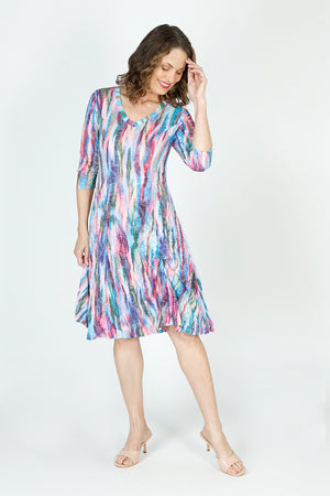 Top Ligne Color Streaks Bubble Dress in Multi.  Bright vertical streaks of color.  Banded v neck with 3/4 sleeve.  Contour seams.  2 front pouch pockets.  Inner ties can be adjusted to create an asymmetrical hemline or flounced tiered hem.  Relaxed fit._59699303416174