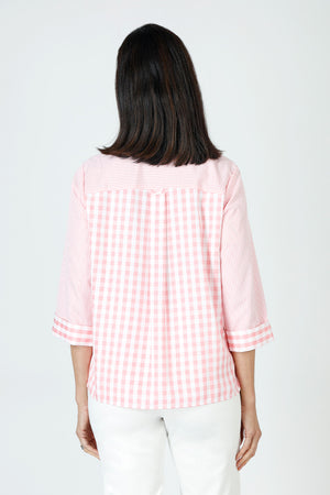 Cali Girls Judy Gingham Blouse in Pink/White.  Mixed size checks.  Pointed collar with open v.  Button front.  3/4 sleeve with fold back cuff.  Single breast patch pocket.  Back yoke with double loop detail.  Side seams wrap slightly to front with curved hem.  Relaxed fit._59821610434926