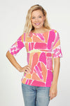 Whimsy Rose Pebble Walk Banded Elbow Sleeve Top in Pink/Orange.  Boatneck, elbow sleeve tee.  Horizontal bands of pleated fabric.  Contrasting print on back.  Fused seams.  Straight hem.  Relaxed fit._t_59784330936686