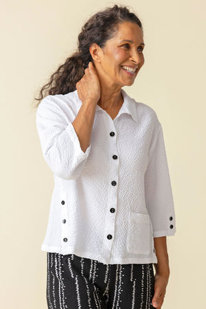 Habitat Crinkle Camp Shirt in White.  Pointed collar button down with black buttons.  Wrapped to front side seams with 3 button detail.  Single front patch pocket.  3/4 sleeve with 2 button detail placket cuff. Back yoke. Relaxed fit._59770350928238