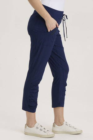 Wearables  Aksana Legging in Legion, a marine blue.  Elastic drawstring waist pant with ruching detail at the front from knee to hem.  Slim leg.  2 front pockets with diagonal zipper detail.  24 1/2" inseam._36290988114120