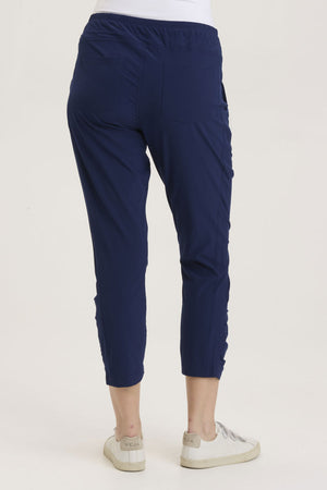 Wearables  Aksana Legging in Legion, a marine blue.  Elastic drawstring waist pant with ruching detail at the front from knee to hem.  Slim leg.  2 front pockets with diagonal zipper detail.  24 1/2" inseam._36290987950280