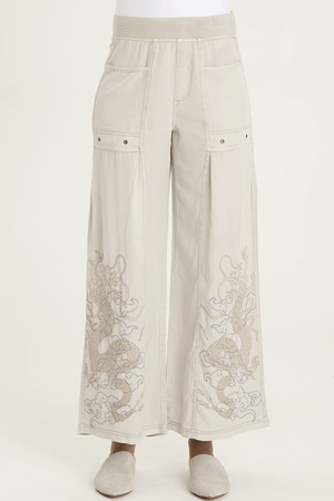 XCVI Pheodora Embroidered Pant in Whitecap, a light beige.  Terry elastic waistband.  2 deep front pockets with grommet detail and soft pleating.  Front center seams.  Hand-drawn embroidery.  2 back patch pockets. Wide leg. 29" inseam._59594501063022