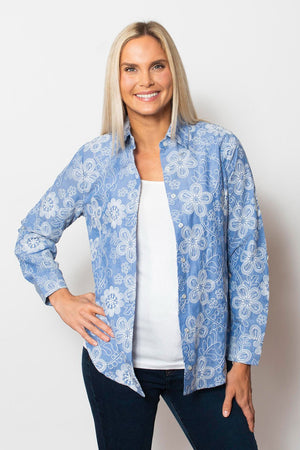 Sno Skins Embroidered Woven Blouse in Wedgewood blue.  Pointed collar button down with white floral  embroidery.  Long sleeves with button cuff and roll button tab.  Shirttail hem.  Relaxed fit._59765753872750