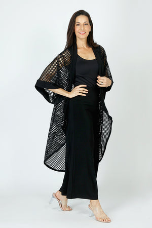 Sympli Honeycomb Kimono in Black.  Open weave high low topper.  Dolman elbow length sleeve.  Honeycomb open weave with solid jersey around neck and front placket and cuff.  
Relaxed fit._59726402847086