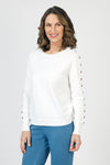 Lolo Luxe Grommet Sweater in White.  Crew neck long sleeve sweater with metal grommet detail down center of each sleeve.  Rib trim at neck, hem and cuff.  Relaxed fit._t_59840767787374