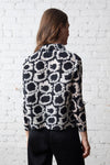 Olivia by Habitat Pleats Circles Jackets in Black.  Abstract circle print.   Horizontal mini accordion pleat button down with pointed collar.  Bracelet length sleeves.  Straight hem. Relaxed fit._t_59821191987566