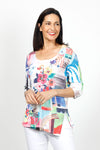 Top Ligne Round Neck Flowers Top in Multi. Bright floral print on a white background. Scooped rounded neck with 3/4 sleeve. Asymmetric front slit with clear sequin trim. Relaxed fit._t_35032526061768