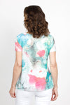 Top Ligne Lace Trim Tie Dye Top in Multi. Bright teal and pink tie dye/watercolor top on a white background. Sublimation printed allowing white streaks to peak through. Notched v neck short sleeve a line top. Asymmetric lace inset at hem. Relaxed fit._t_35487920324808