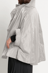 Planet Nylon Chic Cape in Titanium. Cocoon shaped double faced nylon jacket with 2 openings for arms. Cross between cape and a poncho._t_59597913653614