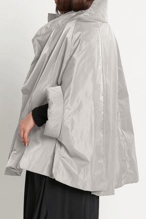 Planet Nylon Chic Cape in Titanium. Cocoon shaped double faced nylon jacket with 2 openings for arms. Cross between cape and a poncho._59597913653614