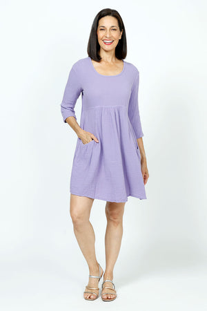 Organic Rags Gauze Dress in Lilac. Cotton gauze scoop neck dress with high waist. 3/4 sleeve. 2 front patch pockets._35729930846408