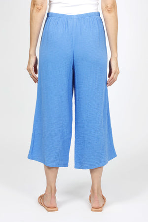 Organic Rags Gauze Pocket Crop in Cornflower blue. Pull on cotton gauze pant with 3/4" contoured flat front waistband, elastic back. Falls straight through the hip, thigh and leg. 2 front pockets. 22" inseam._35151267823816