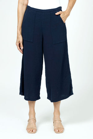 Organic Rags Gauze Pocket Crop in Navy. Pull on cotton gauze pant with 3/4" contoured flat front waistband, elastic back. Falls straight through the hip, thigh and leg. 2 front pockets. 22" inseam._35729899716808