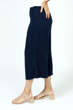 Organic Rags Gauze Pocket Crop in Navy. Pull on cotton gauze pant with 3/4" contoured flat front waistband, elastic back. Falls straight through the hip, thigh and leg. 2 front pockets. 22" inseam._35729899782344